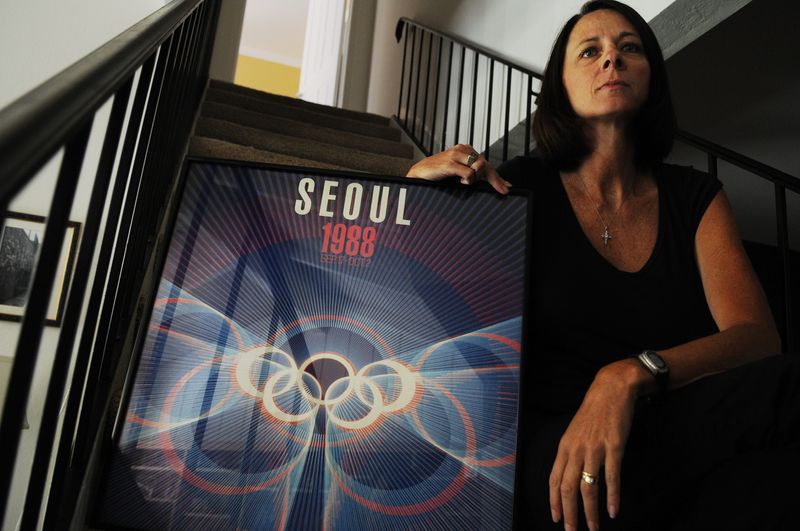 Jayne McHugh, former Pacific volleyball player and coach and member of the 1988 Olympic Women's volleyball team, poses for a portrait while watching a broadcast of the US women's volleyball opening match against Japan at her home in Stockton on Aug. 9, 2008.