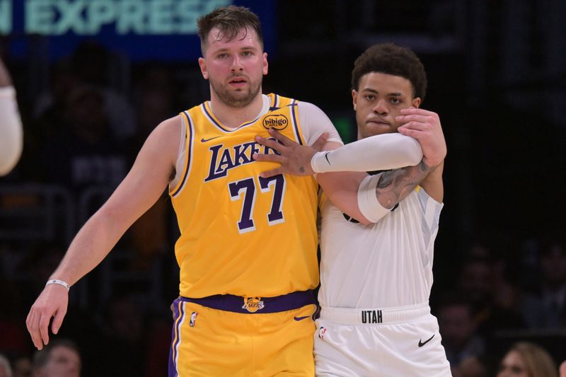 Feb 10, 2025; Los Angeles, California, USA; Los Angeles Lakers guard Luka Doncic (77) and Utah Jazz guard Keyonte George (3) fight for position on the court in the first half at Crypto.com Arena. Mandatory Credit: Jayne Kamin-Oncea-Imagn Images