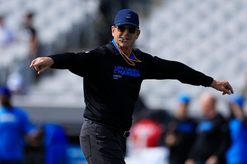 Los Angeles Chargers head coach Jim Harbaugh facilitates duing warmups before an NFL football game at EverBank Stadium, Sunday, Nov. 16, 2025 in Jacksonville, Fla. [Corey Perrine/Florida Times-Union]