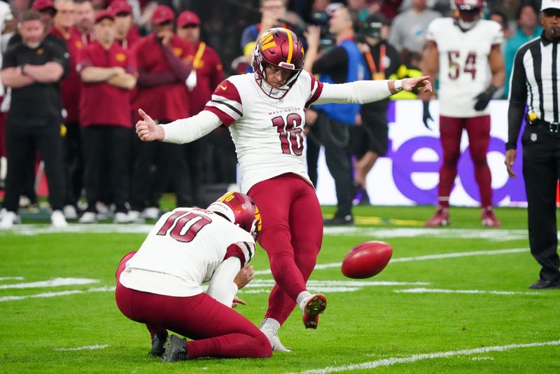 Nov 16, 2025; Madrid, Spain; Washington Commanders place kicker Matt Gay (16) kicks a field goal against the Miami Dolphins in the first quarter during the 2025 NFL Madrid Game at Santiago Bernabeu Stadium. Mandatory Credit: Kirby Lee-Imagn Images