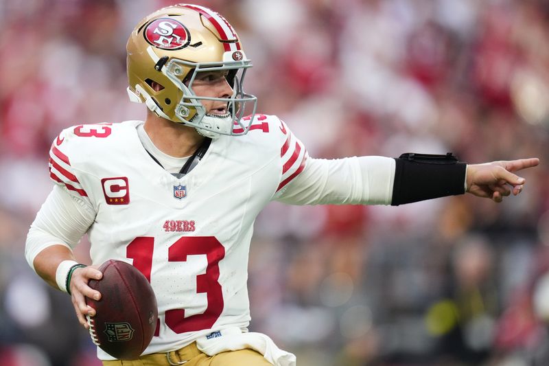 San Francisco 49ers quarterback Brock Purdy (13) scrambles out of the pocket against the Arizona Cardinals at State Farm Stadium in Glendale on Nov. 16, 2025.