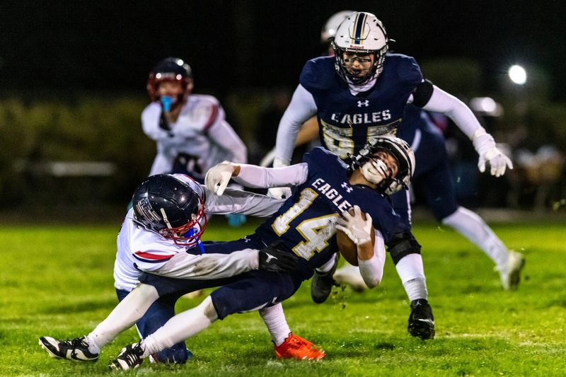 Lancaster Baptist’s Peyton Langley is brought down by Hesperia Christian’s Noah Griffin during CIF-SS 8-Man Division 2 semifinals on Friday, Nov. 21, 2025. Lancaster Baptist won 45-22.