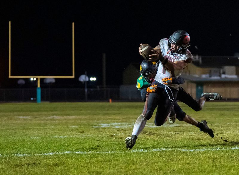 Grace's Jake Williams runs for the game-winning touchdown as Coachella Valley's Albert Terrones makes a hit just a moment late during the fourth quarter of their CIF-SS Division 12 semifinal game in Thermal, Calif., Friday, Nov. 21, 2025.
