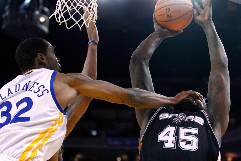 April 26, 2012; Oakland, CA, USA; San Antonio Spurs center DeJuan Blair (45) is fouled by Golden State Warriors center Mickell Gladness (32) while attempting a shot in the second quarter at ORACLE Arena. Mandatory Credit: Cary Edmondson-USA TODAY Sports