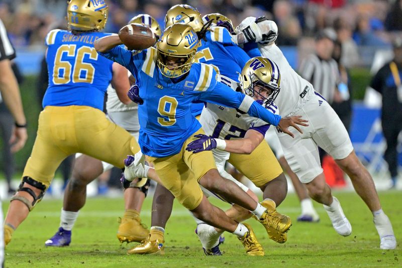 Nov 22, 2025; Pasadena, California, USA; UCLA Bruins quarterback Nico Iamaleava (9) breaks away from Washington Huskies safety Alex McLaughlin (12) during the first half at the Rose Bowl. Mandatory Credit: Jayne Kamin-Oncea-Imagn Images