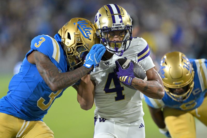 Nov 22, 2025; Pasadena, California, USA; Washington Huskies wide receiver Omari Evans (5) is forced out of bounds by UCLA Bruins defensive back Robert Stafford III (3) after a 9-yard gain during the first half at the Rose Bowl. Mandatory Credit: Jayne Kamin-Oncea-Imagn Images