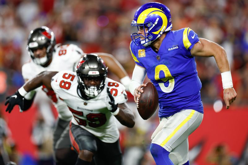 Nov 6, 2022; Tampa, Florida, USA; Los Angeles Rams quarterback Matthew Stafford (9) scrambles with the ball while under pressure from Tampa Bay Buccaneers linebacker Genard Avery (59) during the fourth quarter at Raymond James Stadium. Mandatory Credit: Douglas DeFelice-USA TODAY Sports