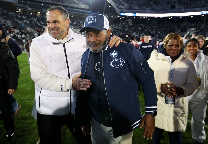 Nov 22, 2025; University Park, Pennsylvania, USA; Penn State Nittany Lions interim head coach Terry Smith is congratulated by athletic director Pat Kraft following the game against the Nebraska Cornhuskers at Beaver Stadium. Mandatory Credit: Matthew O'Haren-Imagn Images
