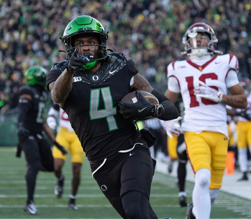 Oregonâ€™s Malik Benson, right, breaks the Southern California coverage on a punt return on his way to a first-half touchdown Nov. 22, 2025.