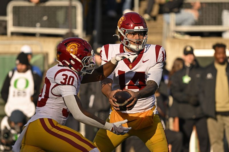 Nov 22, 2025; Eugene, Oregon, USA; Southern California Trojans quarterback Jayden Maiava (14) handles the ball during the game against the Oregon Ducks during the first half at Autzen Stadium. Mandatory Credit: Troy Wayrynen-Imagn Images
