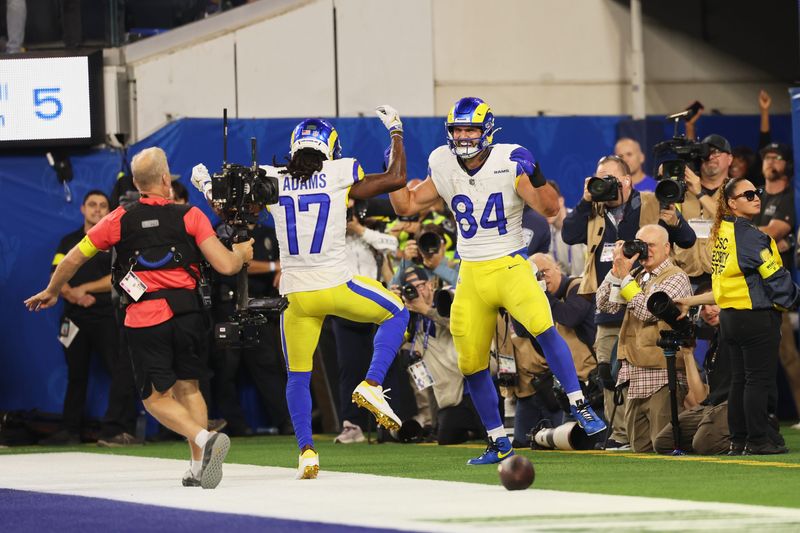 Nov 23, 2025; Inglewood, California, USA; Los Angeles Rams tight end Colby Parkinson (84) celebrates with wide receiver Davante Adams (17) after catching a touchdown pass against the Tampa Bay Buccaneers during the second quarter at SoFi Stadium. Mandatory Credit: Kiyoshi Mio-Imagn Images