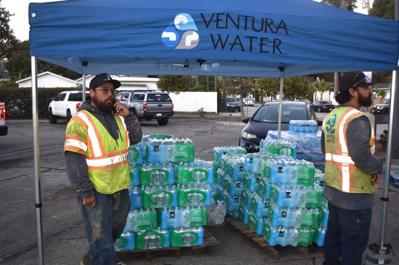 Workers prepare bottled water for pickup on Nov. 25, 2025, outside a maintenance yard off Sanjon Road in Ventura.