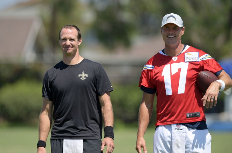 Aug 23, 2018; Costa Mesa, CA, USA: New Orleans Saints quarterback Drew Brees (left) and Los Angeles Chargers quarterback Philip Rivers (17) during joint practice at the Jack. R. Hammett Sports Complex. Mandatory Credit: Kirby Lee-USA TODAY Sports