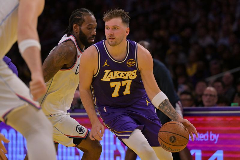 Nov 25, 2025; Los Angeles, California, USA; Los Angeles Lakers guard Luka Doncic (77) drives past Los Angeles Clippers forward Kawhi Leonard (2) during the first half at Crypto.com Arena. Mandatory Credit: Jayne Kamin-Oncea-Imagn Images