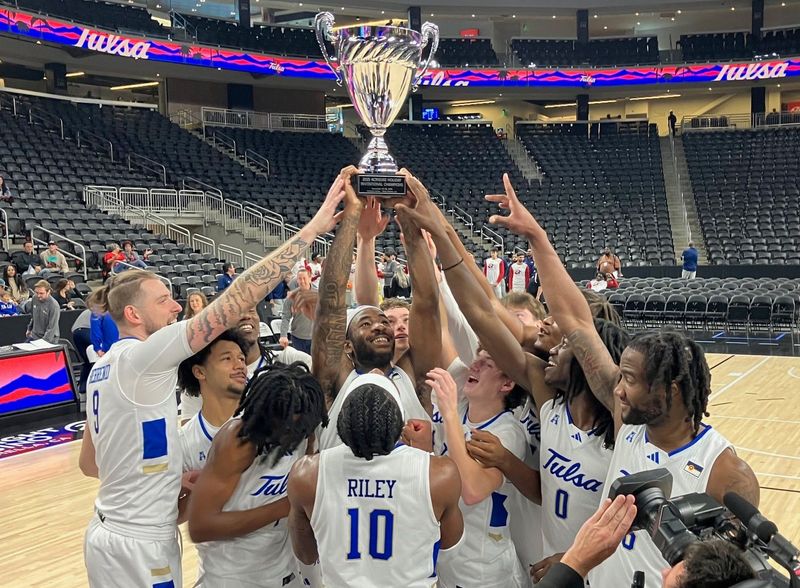 The Tulsa Golden Hurricane men's basketball team celebrates while hoisting the trophy after beating Northern Iowa 63-60 to capture one of four championships handed out at the Acrisure Series in Palm Desert, California on Nov. 26, 2025.