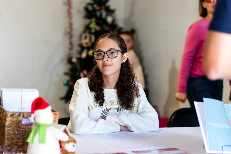 Zoe Garrett, 14, watches as guests arrive to purchase a book at her book launch party in Morongo Valley, Calif., on Sunday, Nov. 23, 2025. Garrett wrote a version of “The Night Before Christmas,” written when she was eleven years old.