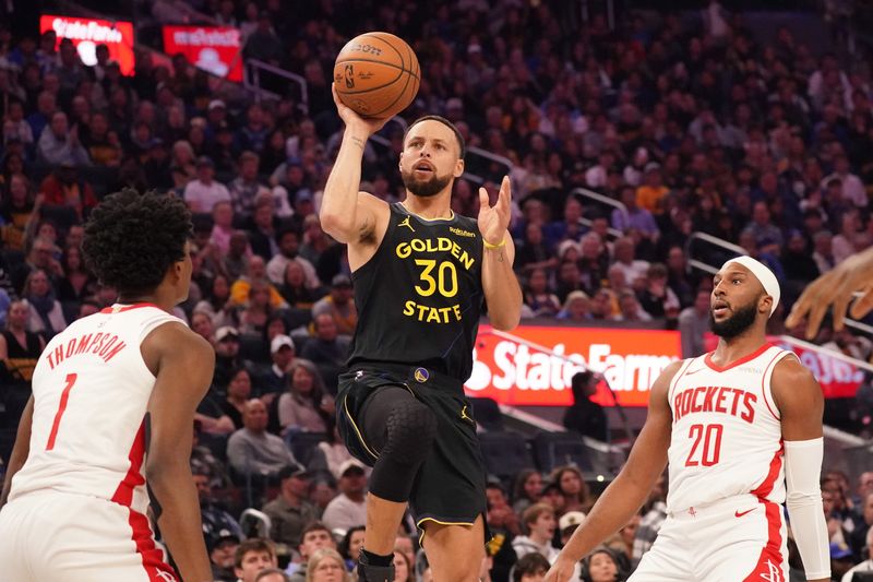 Nov 26, 2025; San Francisco, California, USA; Golden State Warriors guard Stephen Curry (30) shoots while defended by Houston Rockets guard-forward Amen Thompson (1) and forward Jabari Smith (10) in the second quarter at Chase Center. Mandatory Credit: David Gonzales-Imagn Images