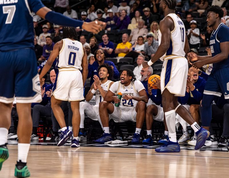 Washington Huskies guard Desmond Claude (1) and center Lathan Sommerville (24) celebrate a basket by guard Quimari Peterson (0) during the first half of their game in the Acrisure Series in Palm Desert, Calif., Thursday, Nov. 27, 2025.