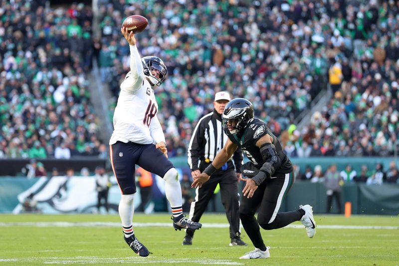 Nov 28, 2025; Philadelphia, Pennsylvania, USA; Chicago Bears quarterback Caleb Williams (18) passes the ball under pressure from Philadelphia Eagles linebacker Nolan Smith Jr. (3) during the first quarter of the game at Lincoln Financial Field. Mandatory Credit: Bill Streicher-Imagn Images