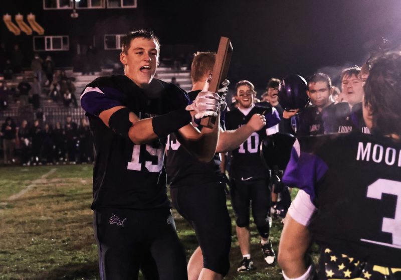 Redding Christian’s Darren Goodman holds the plaque that the team won for defeating Maxwell to become the Northern Section’s Division 5 champions.