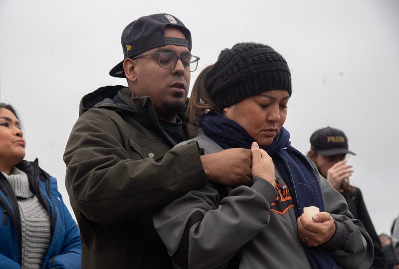 Rodolfo and Tamara Buenrostro-Sugitan attend a vigil on Nov. 30, 2025 remembering the victims of a mass shooting at a children’s birthday party at a banquet hall at in the OutPost shopping center 1t 1955 Lucile Avenue in Stockton. Four people died and 11 were injured in the shooting.