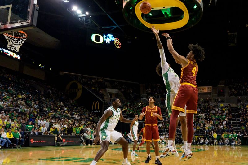 USC guard Chad Baker-Mazara right, takes a shot over Oregon forward Devon Pryor as the Oregon Ducks host the USC Trojans at Matthew Knight Arena in Eugene, Oregon on Dec. 2, 2025.