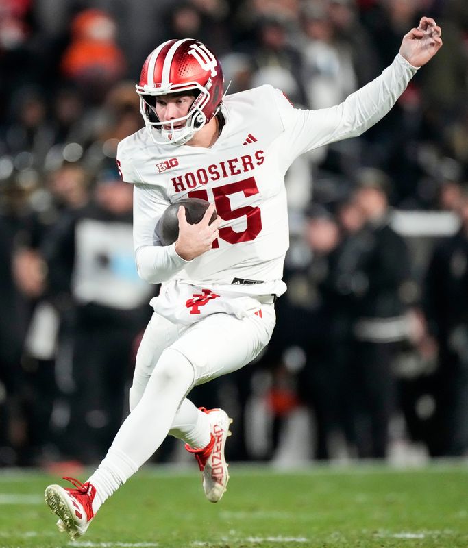 Indiana Hoosiers quarterback Fernando Mendoza (15) rushes up the field Friday, Nov. 28, 2025, during the 100th annual Old Oaken Bucket game at Ross-Ade Stadium in West Lafayette.