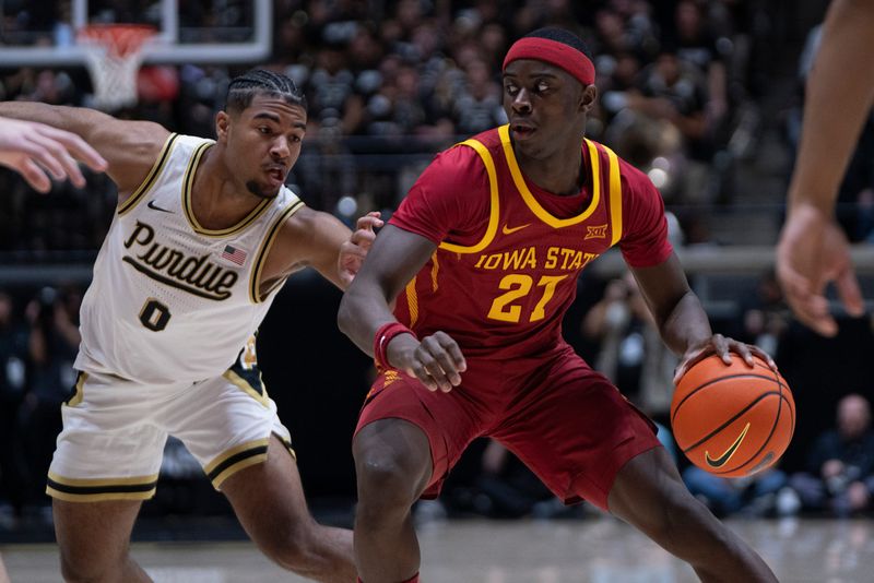Dec 6, 2025; West Lafayette, Indiana, USA; Iowa State Cyclones guard Killyan Toure (27) dribbles the ball around Purdue Boilermakers guard C.J. Cox (0) during the first half against the Purdue Boilermakers at Mackey Arena. Mandatory Credit: Jacob Musselman-Imagn Images