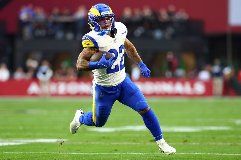 Dec 7, 2025; Glendale, Arizona, USA; Los Angeles Rams running back Blake Corum (22) rushes the ball against the Arizona Cardinals during the first half at State Farm Stadium. Mandatory Credit: Mark J. Rebilas-Imagn Images