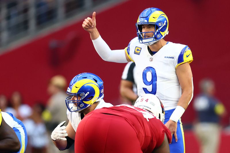 Dec 7, 2025; Glendale, Arizona, USA; Los Angeles Rams quarterback Matthew Stafford (9) reacts against the Arizona Cardinals during the first half at State Farm Stadium. Mandatory Credit: Mark J. Rebilas-Imagn Images