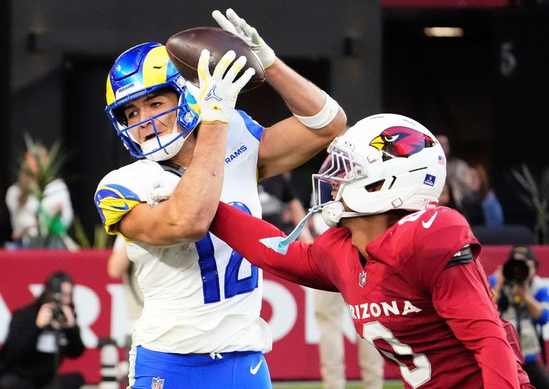Los Angeles Rams wide receiver Puka Nacua (12) makes a touchdown catch over Arizona Cardinals cornerback Will Johnson (0) in the second half at State Farm Stadium on Dec 7, 2025, in Glendale, Ariz.