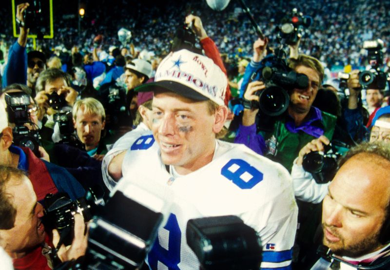Jan 31, 1993; Pasadena, CA, USA; FILE PHOTO; Dallas Cowboys quarterback Troy Aikman (8) talks to the media after defeating the Buffalo Bills 52-17 at Super Bowl XXVII at the Rose Bowl. Mandatory Credit: James D. Smith-USA TODAY Sports