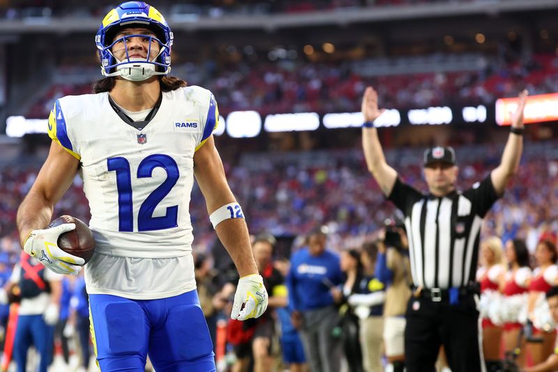 Dec 7, 2025; Glendale, Arizona, USA; Los Angeles Rams wide receiver Puka Nacua (12) makes a catch for a touchdown against the Arizona Cardinals during the second half at State Farm Stadium. Mandatory Credit: Mark J. Rebilas-Imagn Images