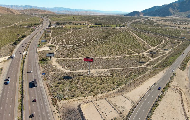 A billboard, center, where Interstate 10 and Highway 111 meet in Palm Springs reads "Welcome to the Agua Caliente Indian Reservation." The land could become a massive warehouse and industrial complex.