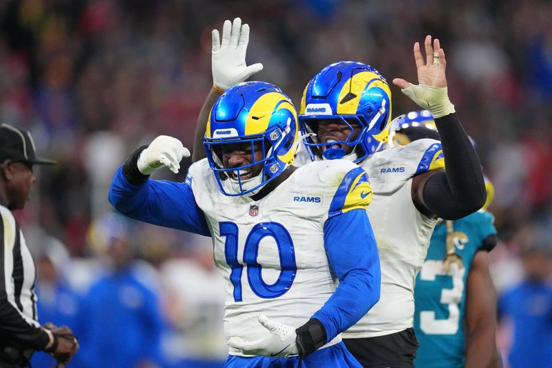 Oct 19, 2025; London, United Kingdom; Los Angeles Rams linebacker Josaiah Stewart (10) and linebacker Jared Verse (8) reacts after a play against the Jacksonville Jaguars during the second half of an NFL International Series game at Wembley Stadium. Mandatory Credit: Kirby Lee-Imagn Images