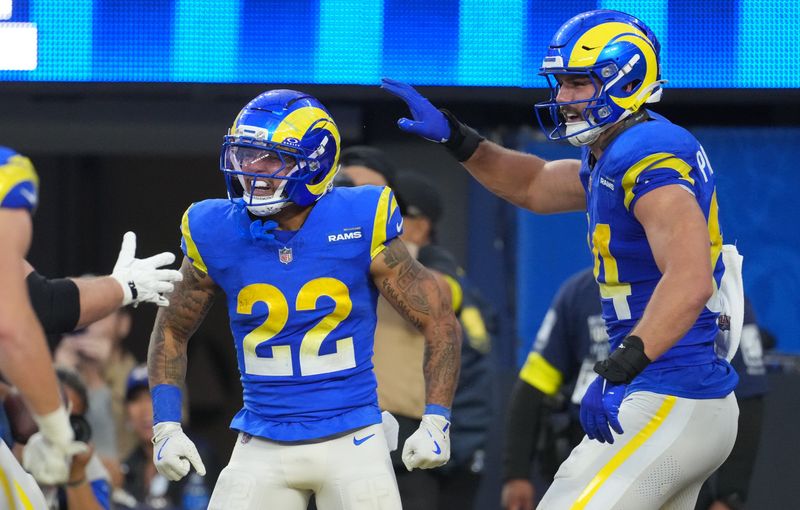 Dec 14, 2025; Inglewood, California, USA; Los Angeles Rams running back Blake Corum (22) and Los Angeles Rams tight end Colby Parkinson (84) celebrate after a touchdown during the third quarter against the Detroit Lions at SoFi Stadium. Mandatory Credit: Kirby Lee-Imagn Images