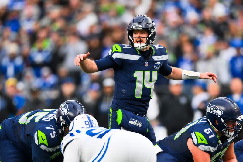 Dec 14, 2025; Seattle, Washington, USA; Seattle Seahawks quarterback Sam Darnold (14) audibles over center against the Indianapolis Colts during the third quarter at Lumen Field. Mandatory Credit: Steven Bisig-Imagn Images