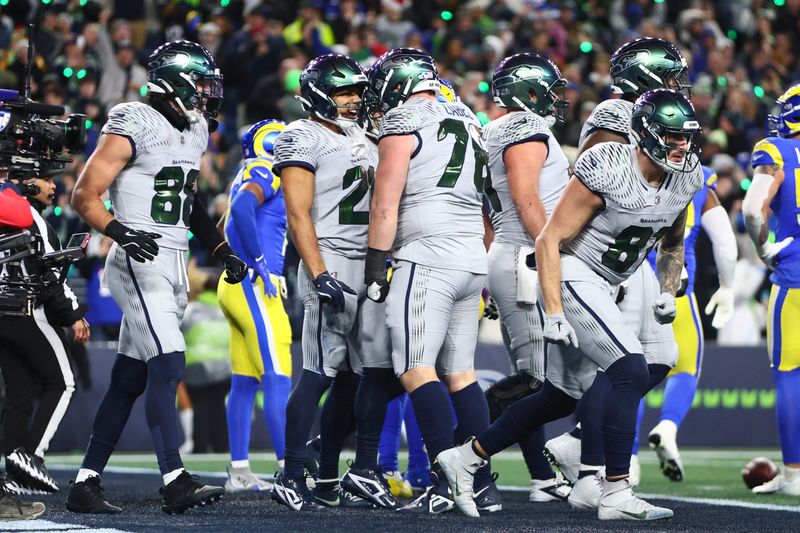 Dec 18, 2025; Seattle, Washington, USA; Seattle Seahawks running back Zach Charbonnet (26) celebrates with teammates after scoring a touchdown against the Los Angeles Rams in the first half at Lumen Field. Mandatory Credit: Kevin Ng-Imagn Images