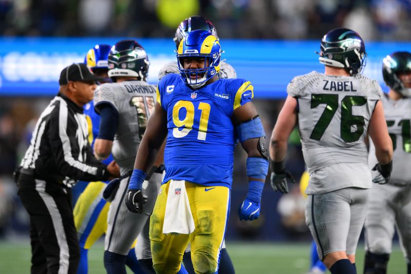 Dec 18, 2025; Seattle, Washington, USA; Los Angeles Rams defensive end Kobie Turner (91) reacts after a sack against the Seattle Seahawks in the second half at Lumen Field. Mandatory Credit: Steven Bisig-Imagn Images