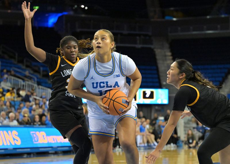 Dec 20, 2025; Los Angeles, California, USA; UCLA Bruins forward Sienna Betts (16) drives past Long Beach State Beach guard Jaquoia Jones-Brown (30) and forward Kennan Ka (5) for a basket during the first half at Pauley Pavilion presented by Wescom Financial. Mandatory Credit: Jayne Kamin-Oncea-Imagn Images