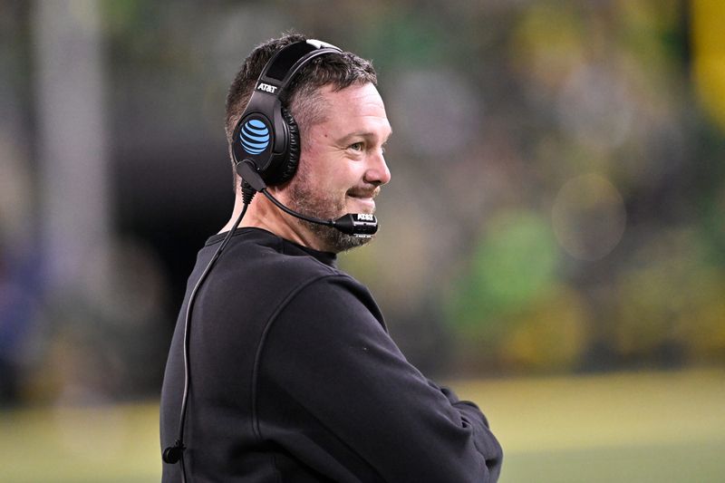 Dec 20, 2025; Eugene, OR, USA; Oregon Ducks head coach Dan Lanning smiles during the third quarter against the James Madison Dukes at Autzen Stadium. Mandatory Credit: Craig Strobeck-Imagn Images