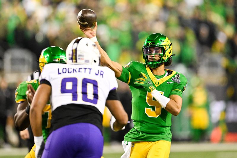 Dec 20, 2025; Eugene, OR, USA; Oregon Ducks quarterback Dante Moore (5) throws a pass during the third quarter against the James Madison Dukes at Autzen Stadium. Mandatory Credit: Troy Wayrynen-Imagn Images