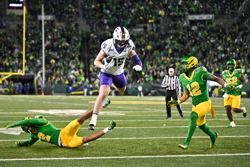 Dec 20, 2025; Eugene, OR, USA; James Madison Dukes tight end Lacota Dippre (15) hurdles over Oregon Ducks defensive back Kingston Lopa (2) to score a touchdown during the fourth quarter at Autzen Stadium. Mandatory Credit: Craig Strobeck-Imagn Images