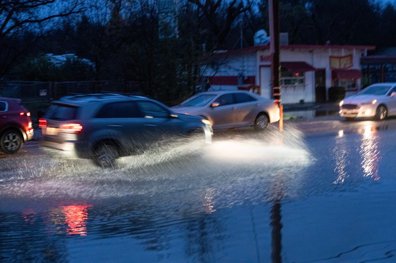 A vehicle pass through the flooded water on Eastside Road in Redding on Monday morning, Dec. 22, 2025.Heavy rain pummeled the region on Sunday causing flooding and power outages.