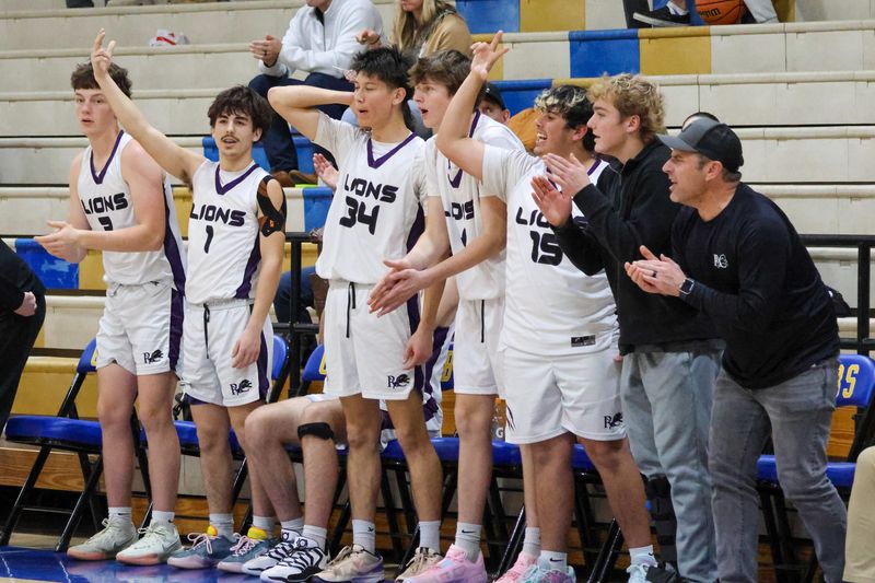 The Redding Christian boys basketball bench celebrates a three-point shot during a game against Durham on Thursday, Dec. 18. The Lions beat the Trojans 45-30 at Anderson High School.