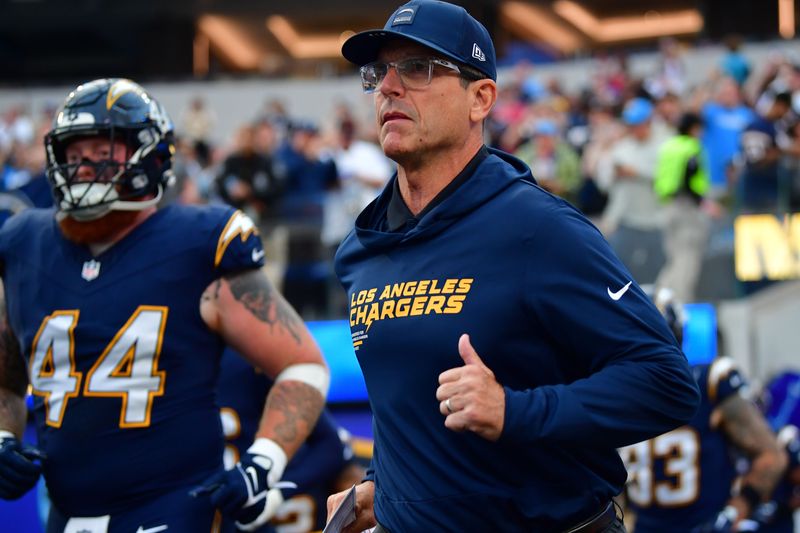 Oct 23, 2025; Inglewood, California, USA; Los Angeles Chargers head coach Jim Harbaugh takes the field against the Minnesota Vikings before the game at SoFi Stadium. Mandatory Credit: Gary A. Vasquez-Imagn Images