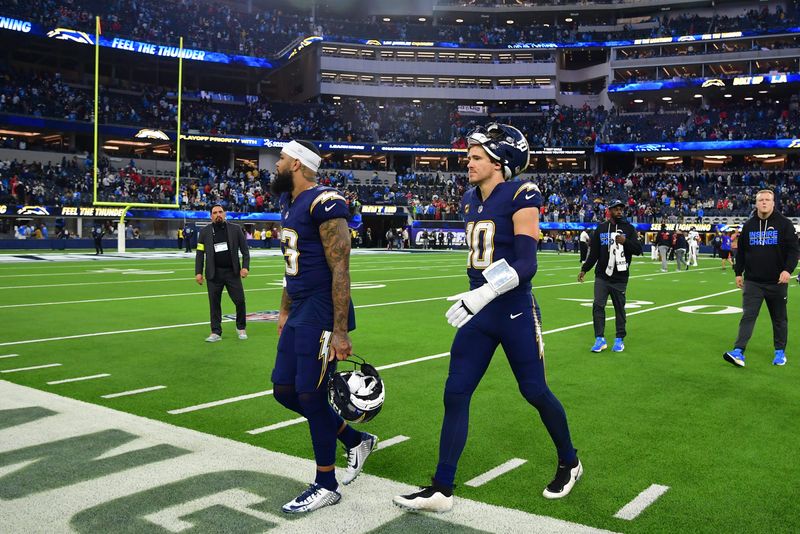Dec 27, 2025; Inglewood, California, USA; Los Angeles Chargers wide receiver Keenan Allen (13) and quarterback Justin Herbert (10) leave the field following a game against the Houston Texans at SoFi Stadium. Mandatory Credit: Gary A. Vasquez-Imagn Images