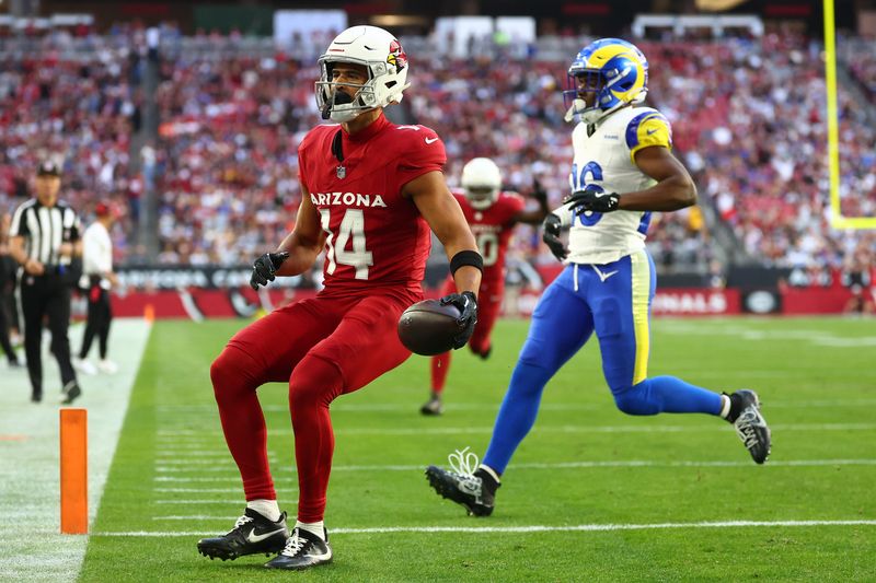 Dec 7, 2025; Glendale, Arizona, USA; Arizona Cardinals wide receiver Michael Wilson (14) runs for a touchdown after a catch against Los Angeles Rams safety Kamren Kinchens (26) during the first half at State Farm Stadium. Mandatory Credit: Mark J. Rebilas-Imagn Images
