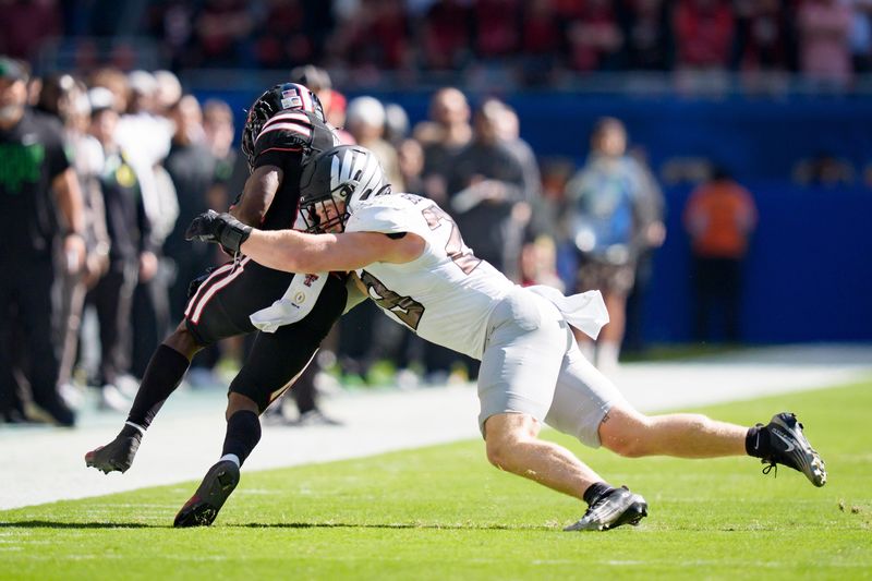 Oregon inside linebacker Bryce Boettcher, right, brings down Texas Tech running back J'Koby Williams as the Oregon Ducks take on the Texas Tech Red Raiders in the Orange Bowl on Jan. 1, 2026, at Hard Rock Stadium in Miami, Florida.