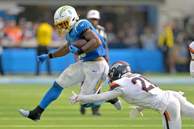 Sep 21, 2025; Inglewood, California, USA; Los Angeles Chargers running back Omarion Hampton (8) is tripped up by Denver Broncos cornerback Riley Moss (21) after a first down in the fourth quarter at SoFi Stadium. Mandatory Credit: Jayne Kamin-Oncea-Imagn Images